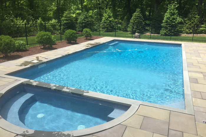 in-ground pool with spa